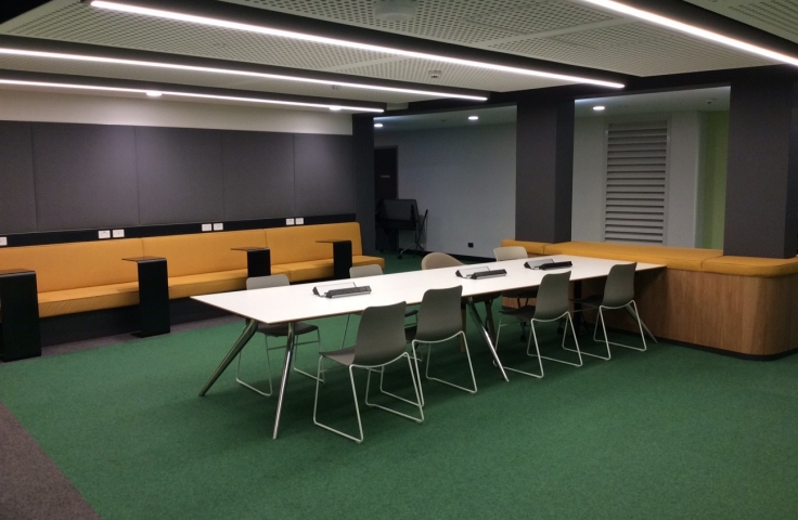 UNSW Goldstein Hall student study spaces with orange couches and white tables