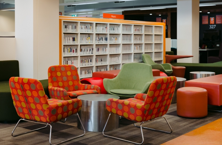 UNSW main library with colourful red chairs around a metal table