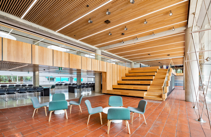 UNSW Red Centre Gallery student study space with teal seats and white tables